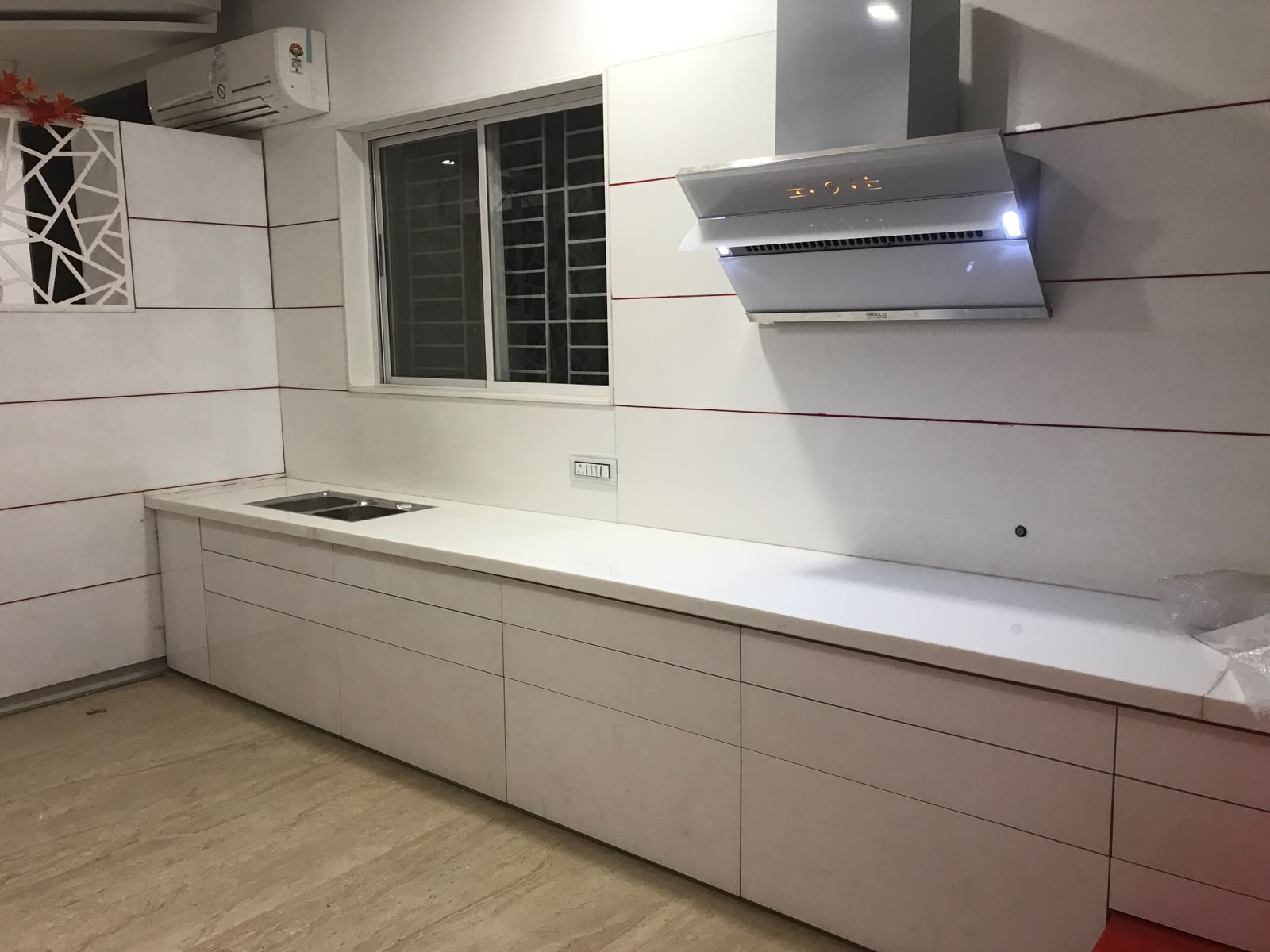 Modular kitchen in Aurangabad with tall units, built-in oven and wooden open shelving by More Than Kitchen